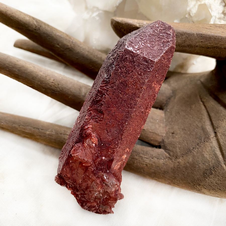 Raw naturally etched Quartz point encrusted with Hematite