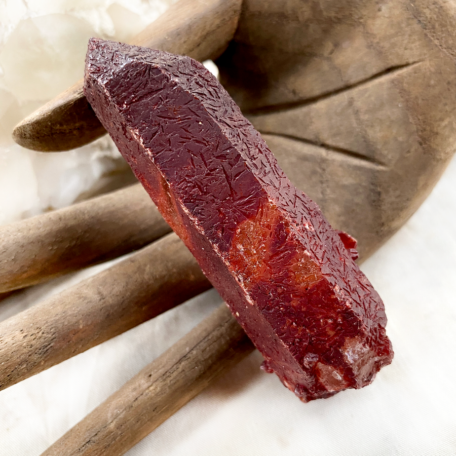 Raw naturally etched Quartz point encrusted with Hematite