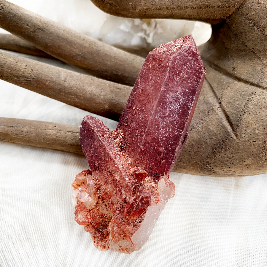 Raw naturally etched Quartz point encrusted with Hematite