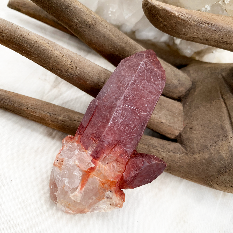 Raw naturally etched Quartz point encrusted with Hematite