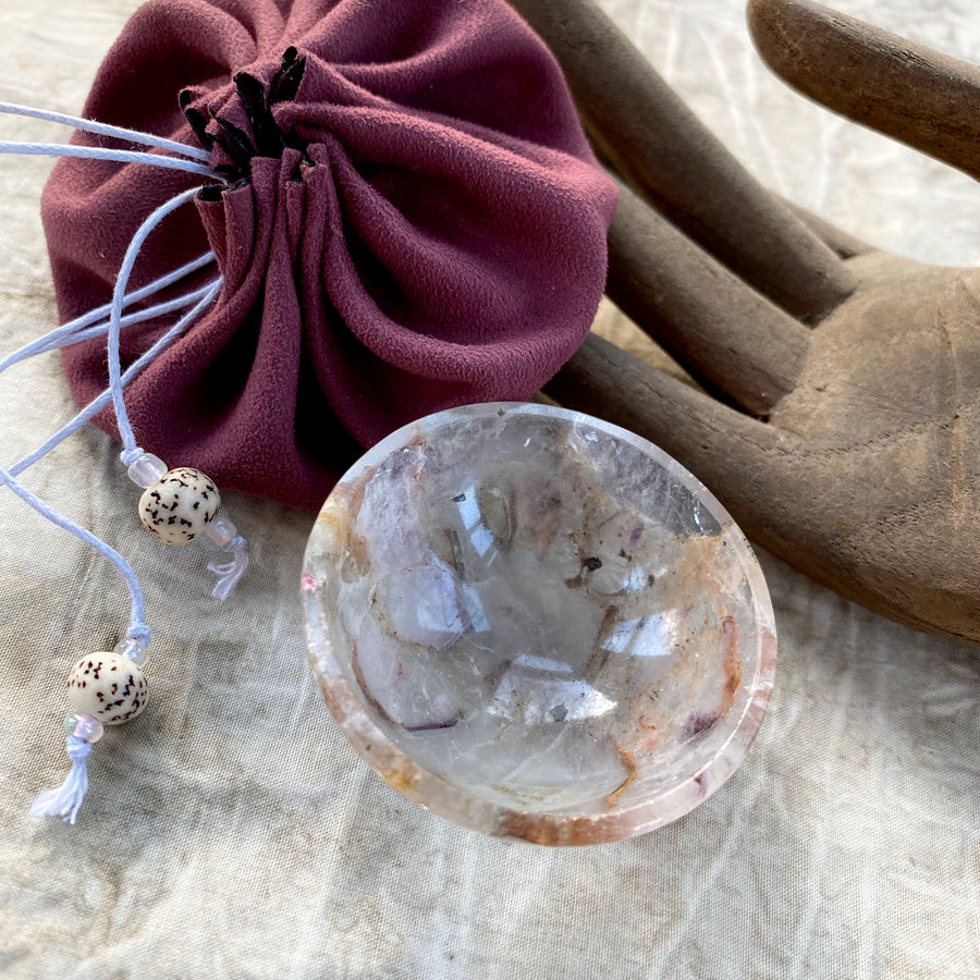 Tiny decorative crystal bowl carved from pale Amethyst with inclusions