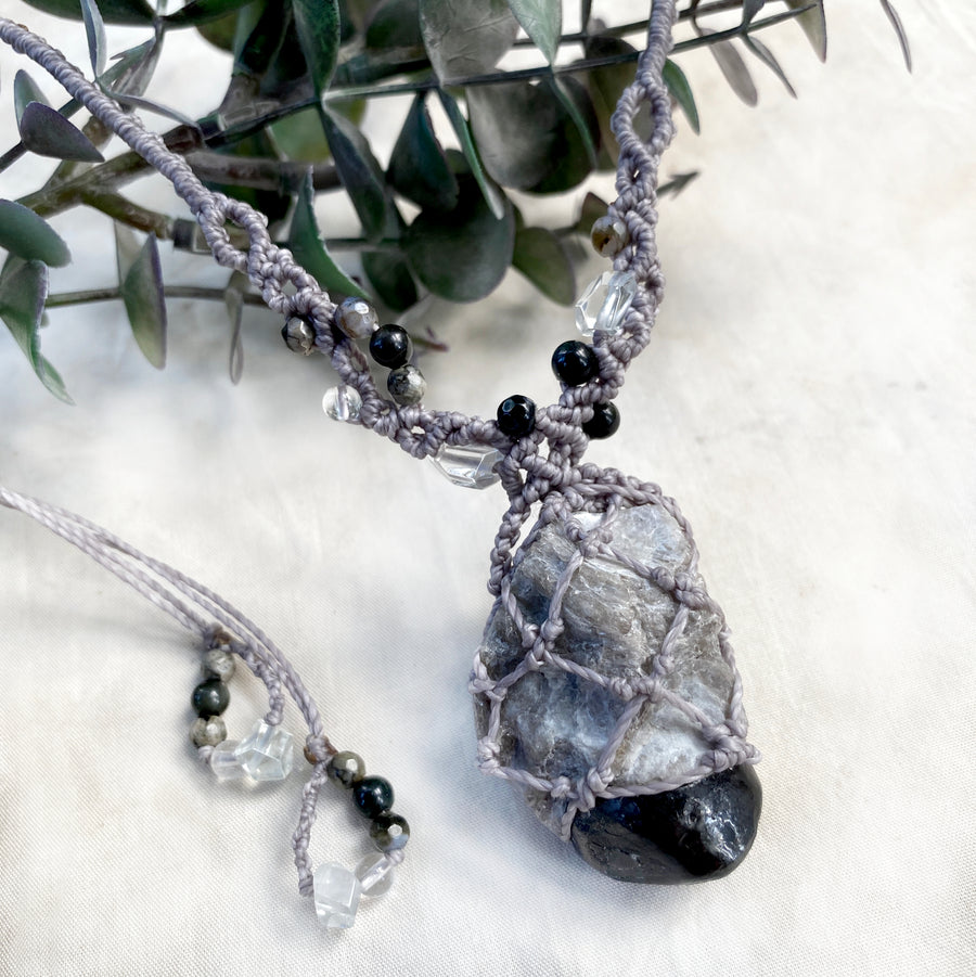 Crystal healing amulet with Apache Tear Obsidian in matrix