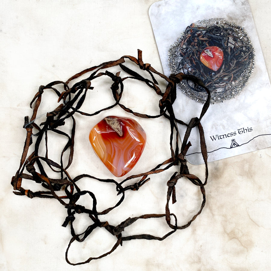 Altar elements: Carnelian pebble with a strand of leather chain (as featured in Spirit Carrier oracle)