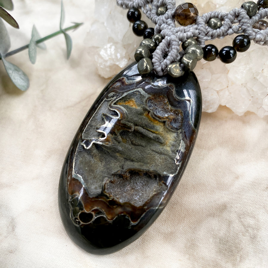 Crystal healing amulet with Pyrite in Simbircite Ammonite