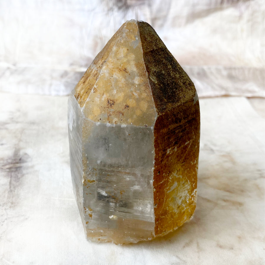 Raw, free-standing Quartz point with iron oxide coating