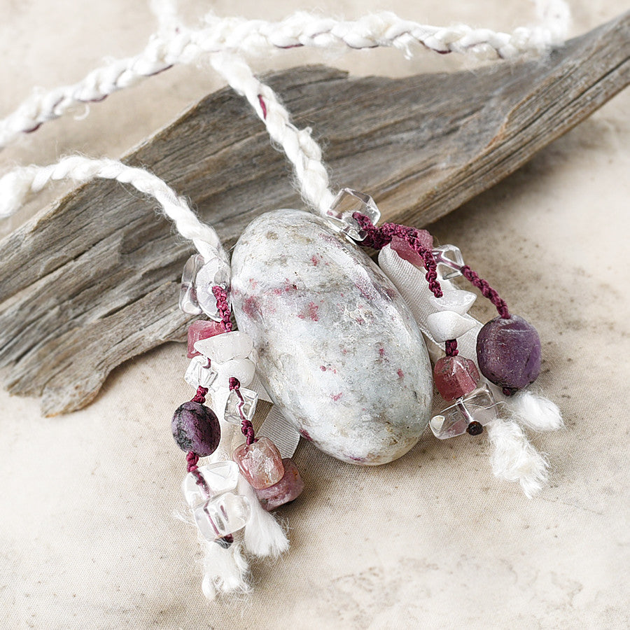 Stone talisman with Ruby in white Quartz