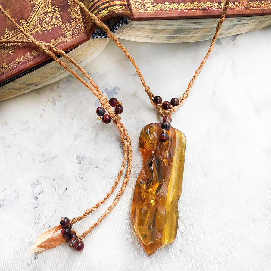 Amber crystal healing amulet with Red Tiger Eye